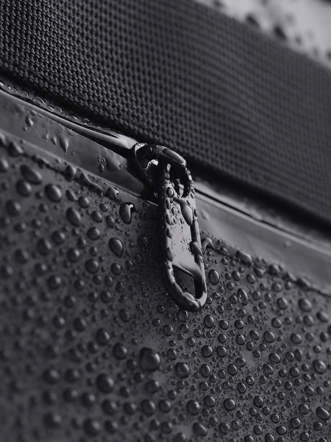 Water droplets on the water-resistant fabric and zipper of a CISTA tote.